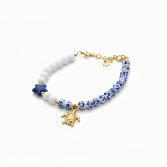 Pulsera de acero con cuentas de porcelana de estampado floral y lisas y con dije de tortuga - Moments by You
