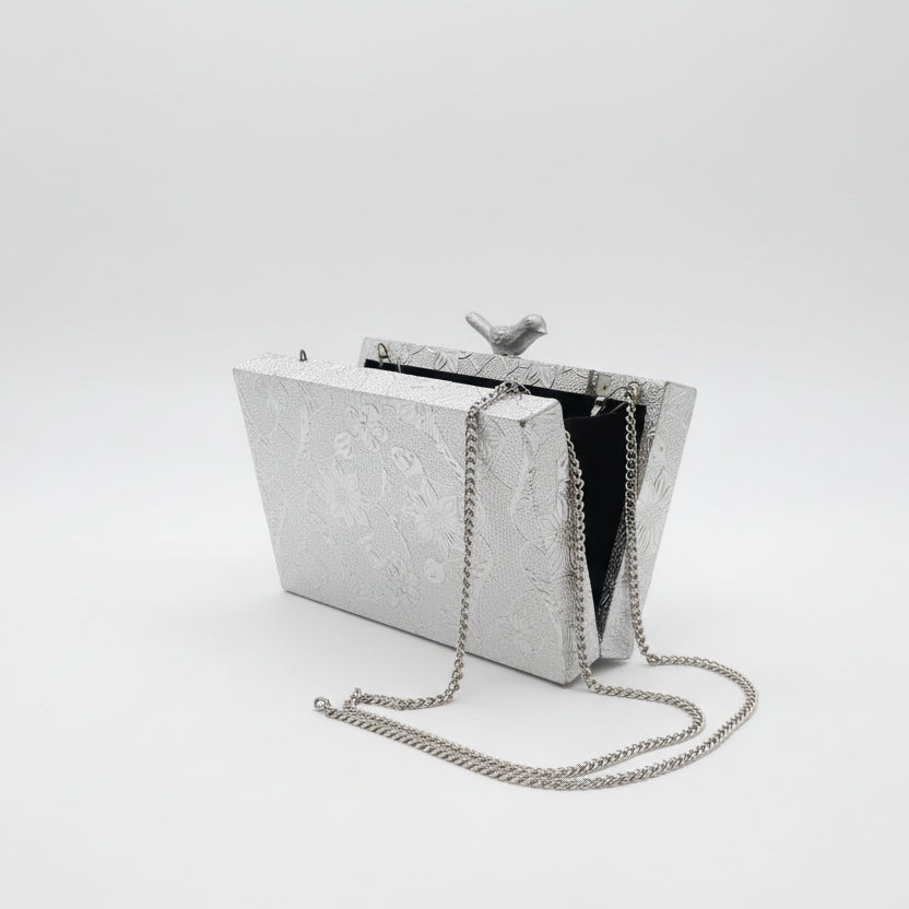 Bolso clutch de fiesta con estampado floral y figura de ave en acabado plata - Moments by You