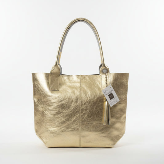 Bolso de piel 100% vacuno tipo shopper alargado en dorado con borla y monedero