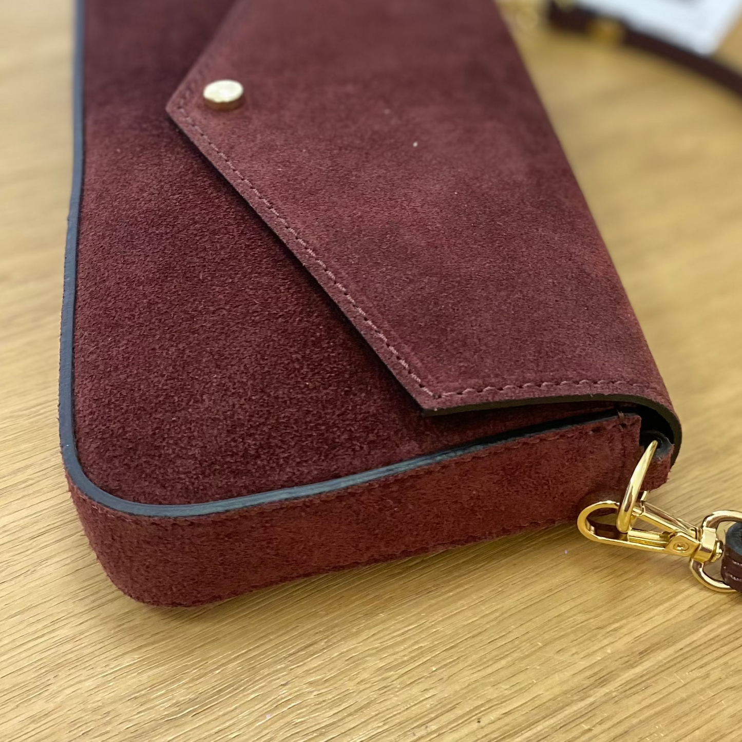 Bolso pequeño de piel 100% vacuno acabado ante con solapa y detalles en dorado color burdeos  - mbyou