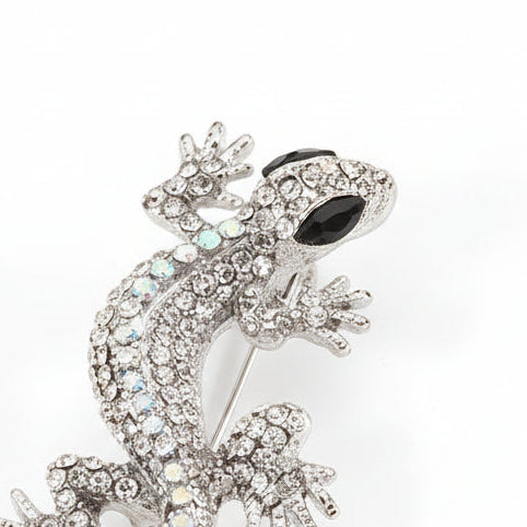 Broche en forma de lagartija en color blanco, ojos negros y acabado plata